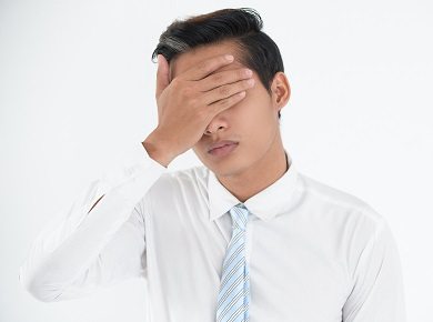 Face of worried young businessman making mistake Face of worried young businessman making mistake